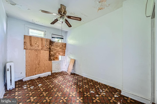 empty room with baseboards and ceiling fan