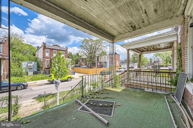 view of patio with a porch and fence