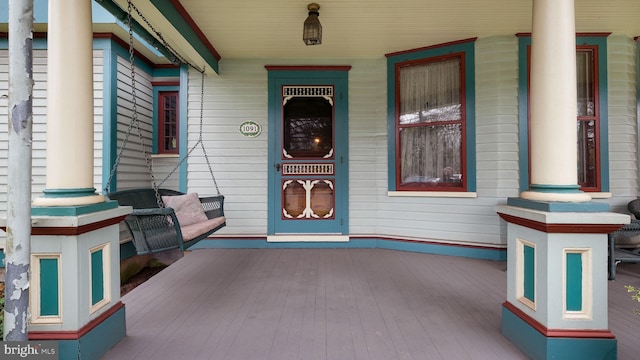 view of exterior entry featuring a porch