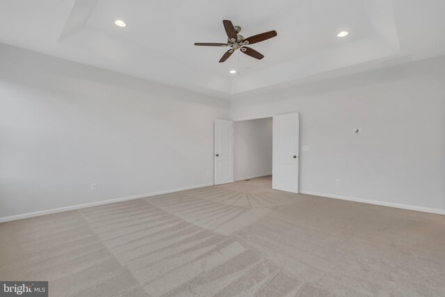 42482 Benfold Sq, Ashburn, VA 20148 - spare room featuring a tray ceiling, light carpet, ceiling fan, recessed lighting, and baseboards