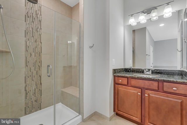 42482 Benfold Sq, Ashburn, VA 20148 - full bathroom featuring a stall shower, vanity, baseboards, and tile patterned floors