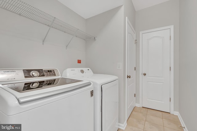 42482 Benfold Sq, Ashburn, VA 20148 - laundry room with washing machine and dryer, light tile patterned floors, and baseboards