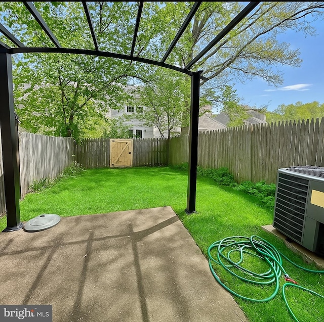 view of yard featuring a fenced backyard, a patio area, central AC, and a gate