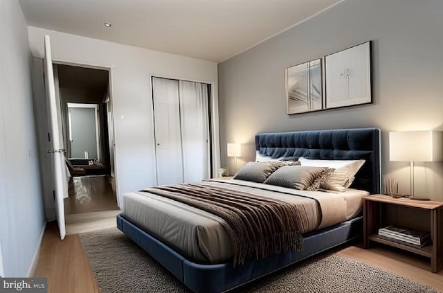 bedroom featuring a closet, baseboards, and light wood-type flooring