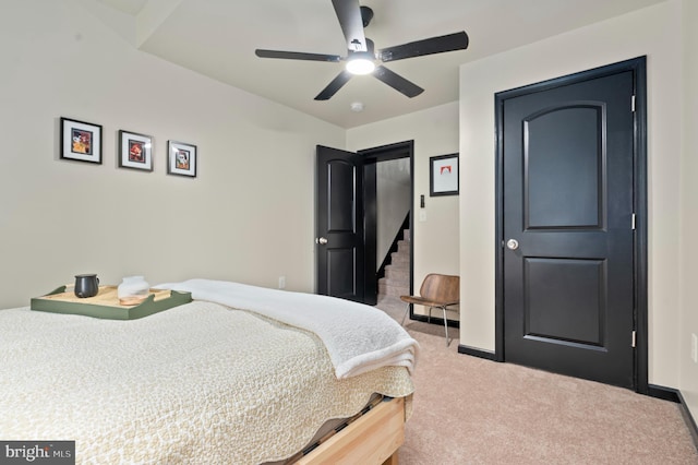 carpeted bedroom featuring a ceiling fan and baseboards