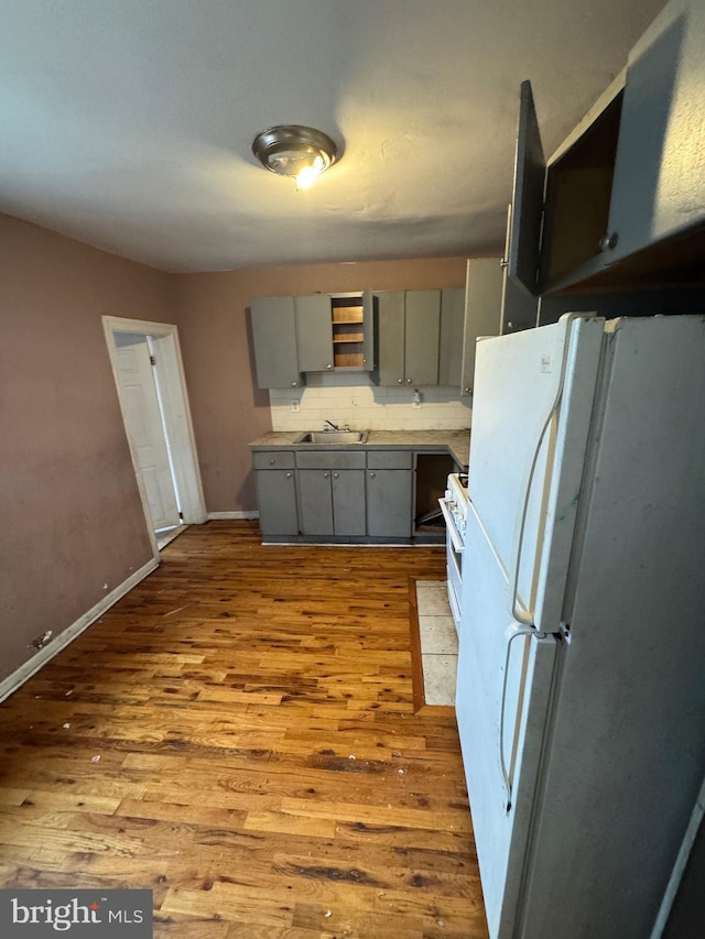 1230adams Adams, Philadelphia, PA 19124 - kitchen featuring gray cabinetry, white appliances, a sink, and wood finished floors