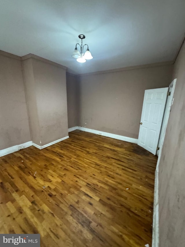 1230adams Adams, Philadelphia, PA 19124 - empty room with an inviting chandelier, baseboards, ornamental molding, and wood finished floors