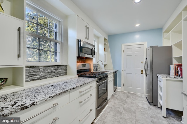 1122 Bellemore Rd, Baltimore, MD 21210 - kitchen with open shelves, appliances with stainless steel finishes, white cabinetry, recessed lighting, and decorative backsplash