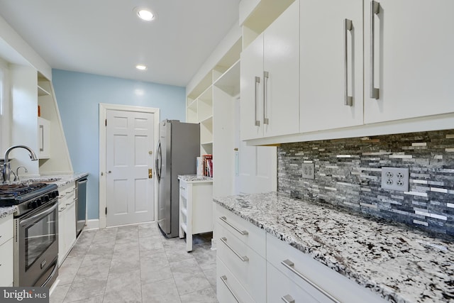 1122 Bellemore Rd, Baltimore, MD 21210 - kitchen featuring open shelves, a sink, appliances with stainless steel finishes, decorative backsplash, and light stone counters