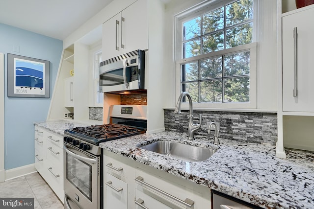 1122 Bellemore Rd, Baltimore, MD 21210 - kitchen featuring a sink, tasteful backsplash, appliances with stainless steel finishes, and white cabinets
