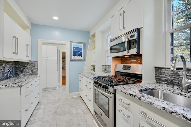 1122 Bellemore Rd, Baltimore, MD 21210 - kitchen featuring a sink, backsplash, and stainless steel appliances