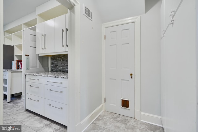 1122 Bellemore Rd, Baltimore, MD 21210 - interior space with marble finish floor, visible vents, baseboards, and white cabinetry