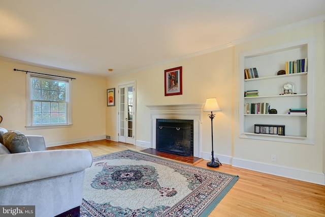1122 Bellemore Rd, Baltimore, MD 21210 - living room with a fireplace, baseboards, ornamental molding, and wood finished floors