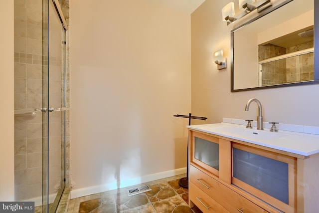 1122 Bellemore Rd, Baltimore, MD 21210 - full bath featuring tiled shower, vanity, visible vents, and baseboards