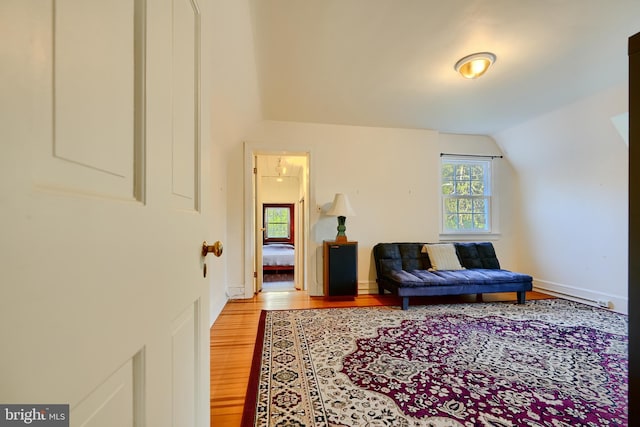 1122 Bellemore Rd, Baltimore, MD 21210 - sitting room with wood finished floors, a baseboard heating unit, baseboards, and vaulted ceiling