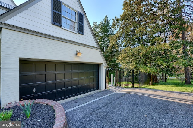 1122 Bellemore Rd, Baltimore, MD 21210 - garage with driveway, fence, and a gate