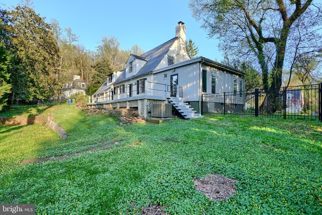 1122 Bellemore Rd, Baltimore, MD 21210 - back of house featuring a deck, a lawn, a chimney, fence, and central air condition unit