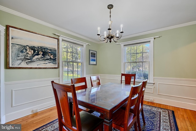 1122 Bellemore Rd, Baltimore, MD 21210 - dining space featuring wainscoting, an inviting chandelier, crown molding, and a healthy amount of sunlight
