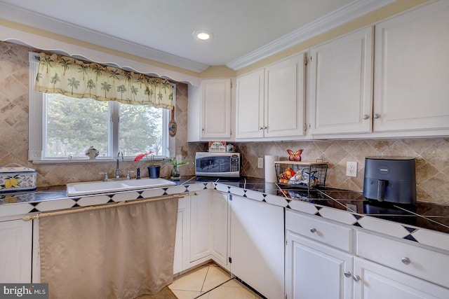 26039 Hidden Acres Ln, Millsboro, DE 19966 - kitchen with tasteful backsplash, white cabinetry, light tile patterned flooring, stainless steel microwave, and a sink