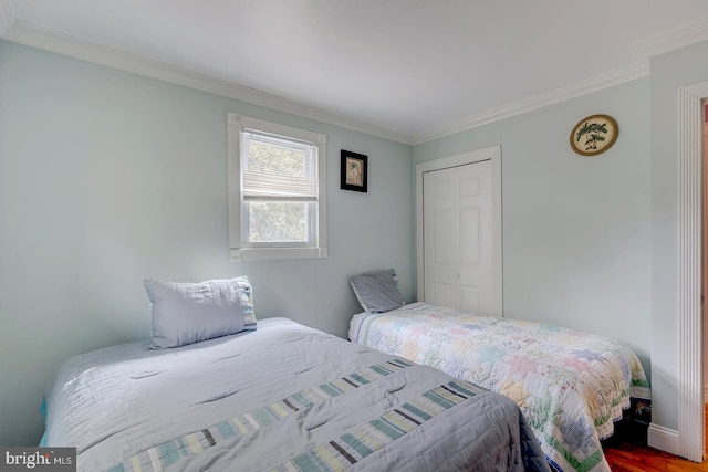 26039 Hidden Acres Ln, Millsboro, DE 19966 - bedroom featuring a closet, wood finished floors, and ornamental molding