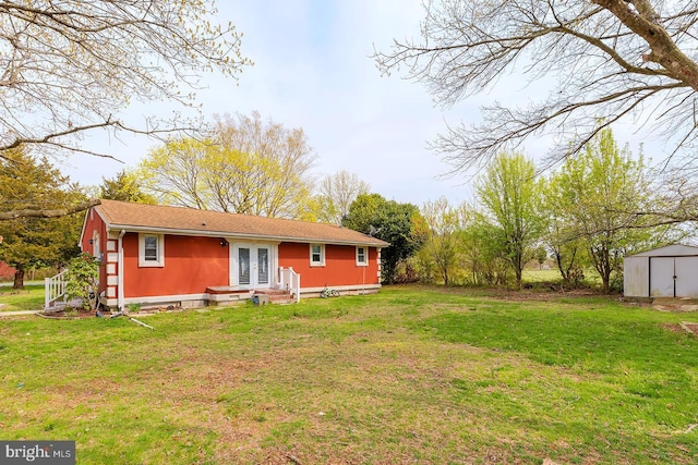 26039 Hidden Acres Ln, Millsboro, DE 19966 - rear view of house featuring an outdoor structure, french doors, entry steps, a lawn, and a storage unit