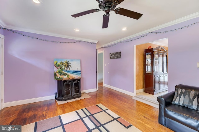 26039 Hidden Acres Ln, Millsboro, DE 19966 - living room with light wood-style flooring, baseboards, ornamental molding, and ceiling fan