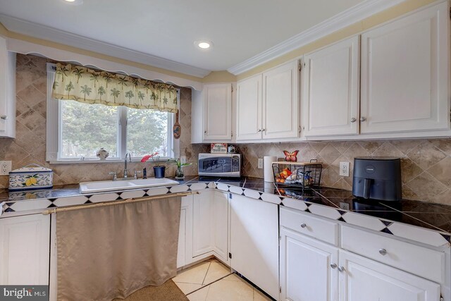 26039 Hidden Acres Ln, Millsboro, DE 19966 - kitchen with stainless steel microwave, tasteful backsplash, white cabinetry, and a sink
