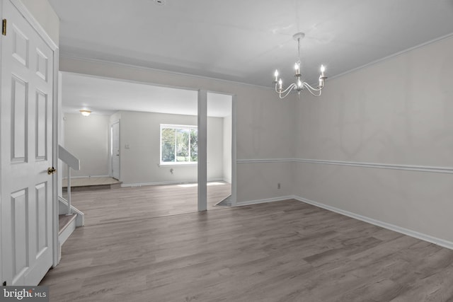 3 Bennington Pl, Newtown, PA 18940 - empty room featuring baseboards, a chandelier, crown molding, wood finished floors, and stairs
