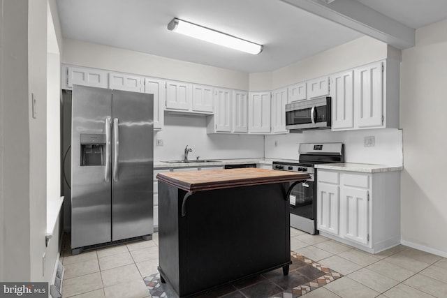 3 Bennington Pl, Newtown, PA 18940 - kitchen with wood counters, light tile patterned floors, a sink, and stainless steel appliances
