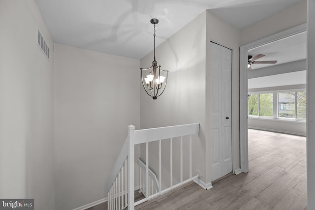 3 Bennington Pl, Newtown, PA 18940 - stairs featuring visible vents, baseboards, ceiling fan with notable chandelier, and wood finished floors