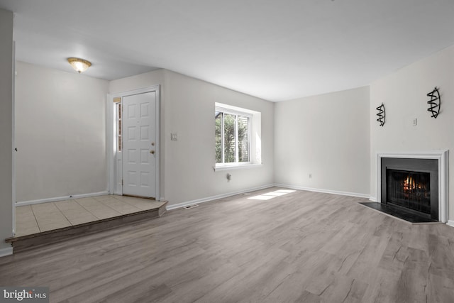 3 Bennington Pl, Newtown, PA 18940 - unfurnished living room with a fireplace with flush hearth, wood finished floors, and baseboards