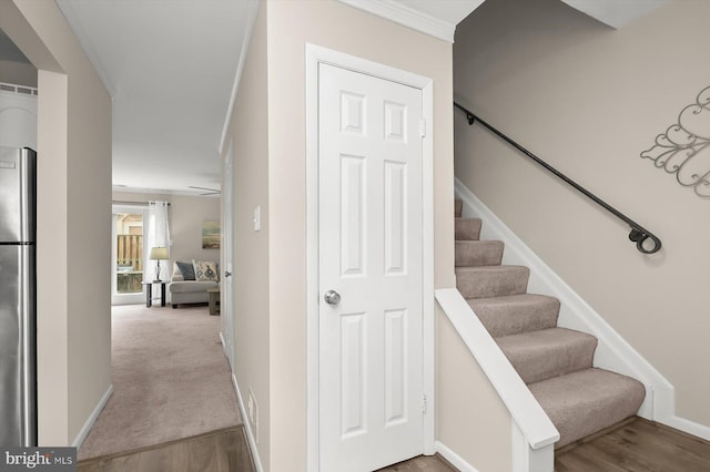 stairs featuring baseboards and wood finished floors