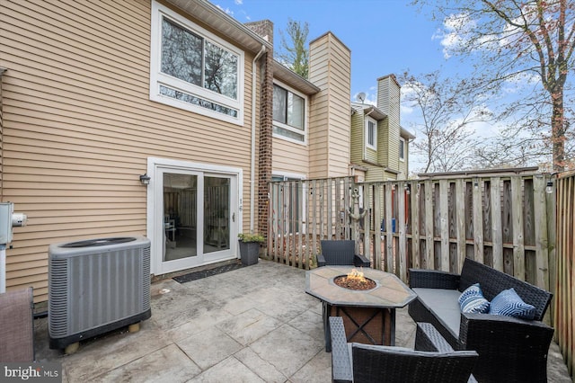 view of patio / terrace featuring fence, a fire pit, and central AC