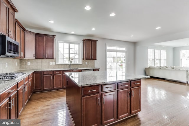 kitchen featuring a sink, appliances with stainless steel finishes, and a healthy amount of sunlight