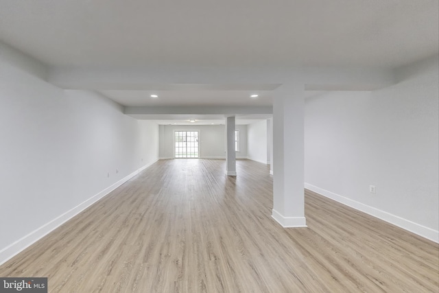interior space with baseboards, wood finished floors, and recessed lighting