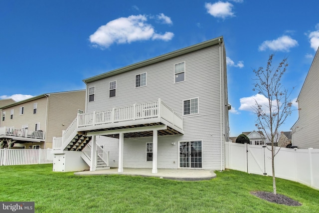 back of house with a deck, a lawn, a fenced backyard, a patio, and stairs