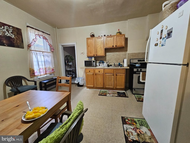 kitchen featuring light countertops, brown cabinets, stainless steel appliances, decorative backsplash, and light floors