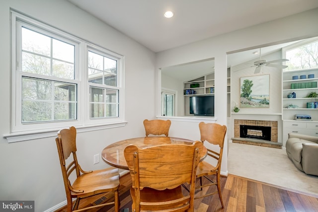 10 Fullview Ct, Gaithersburg, MD 20878 - dining room featuring recessed lighting, lofted ceiling, wood finished floors, a fireplace, and built in shelves