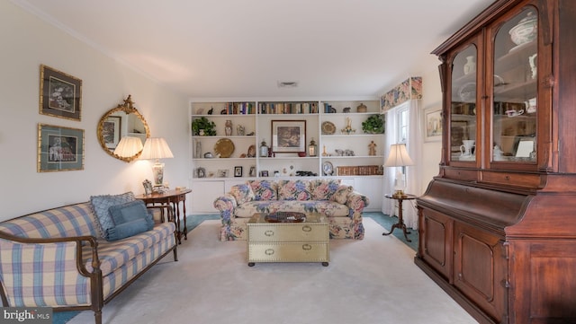 carpeted living room featuring crown molding and built in features