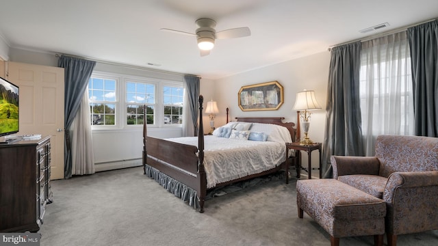 carpeted bedroom featuring baseboard heating, ceiling fan, and visible vents
