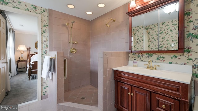 full bathroom featuring vanity, wallpapered walls, recessed lighting, connected bathroom, and a tile shower