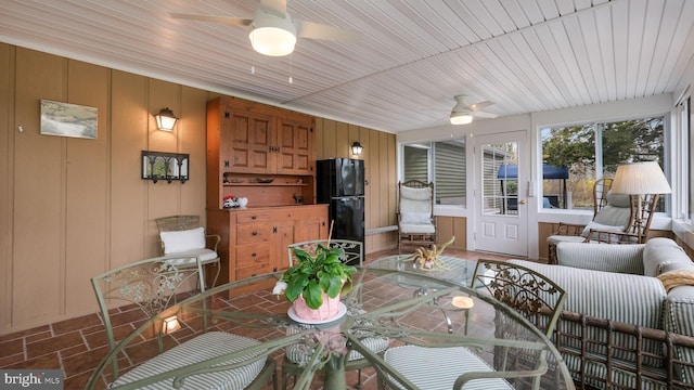 sunroom featuring ceiling fan and outdoor dining area