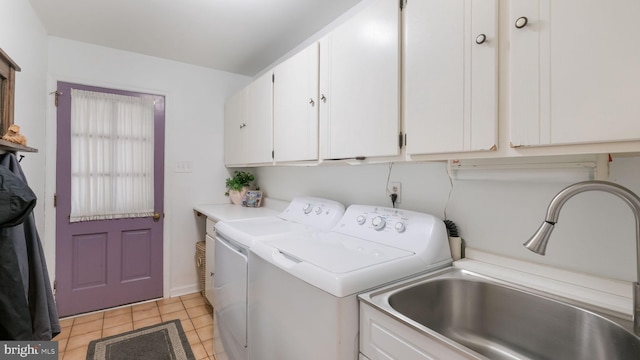washroom with cabinet space, washer and clothes dryer, light tile patterned flooring, and a sink