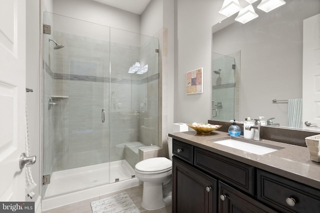 bathroom with toilet, a stall shower, and vanity