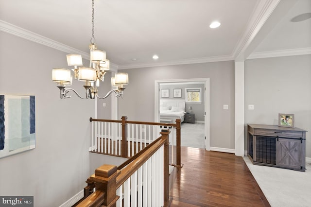 corridor with baseboards, ornamental molding, a chandelier, recessed lighting, and an upstairs landing