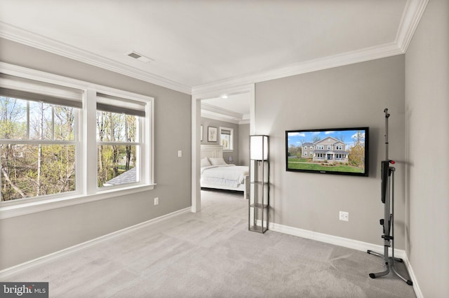 unfurnished bedroom with crown molding, visible vents, baseboards, and carpet