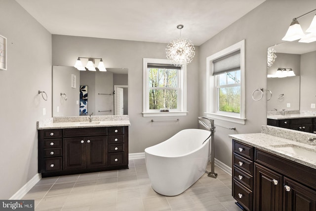 full bathroom featuring a sink, baseboards, and a soaking tub