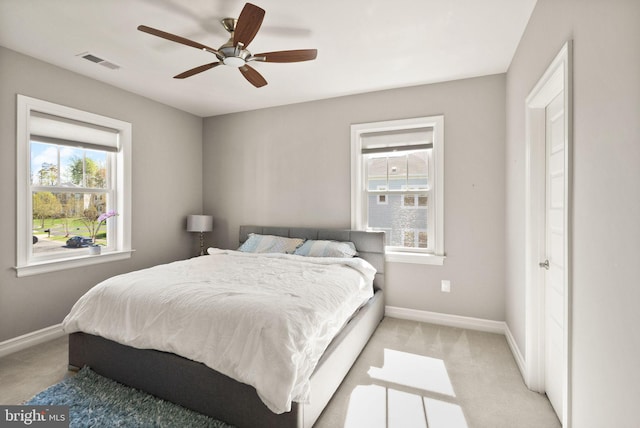 bedroom featuring visible vents, baseboards, and multiple windows