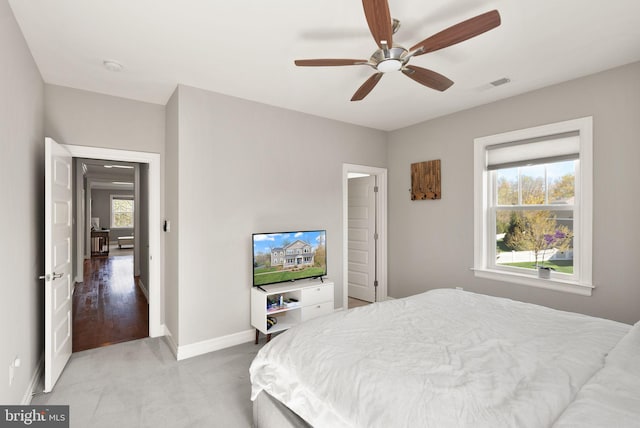 bedroom featuring light colored carpet, baseboards, a ceiling fan, and visible vents