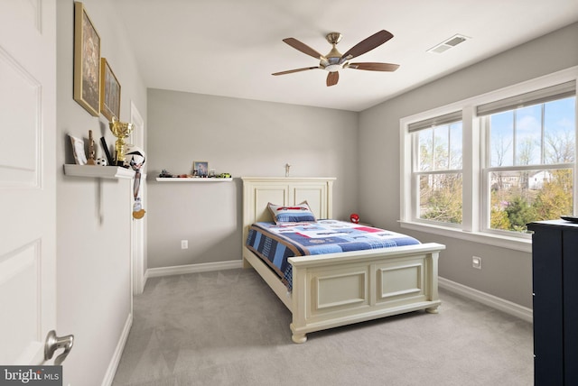 bedroom with light carpet, baseboards, a ceiling fan, and visible vents